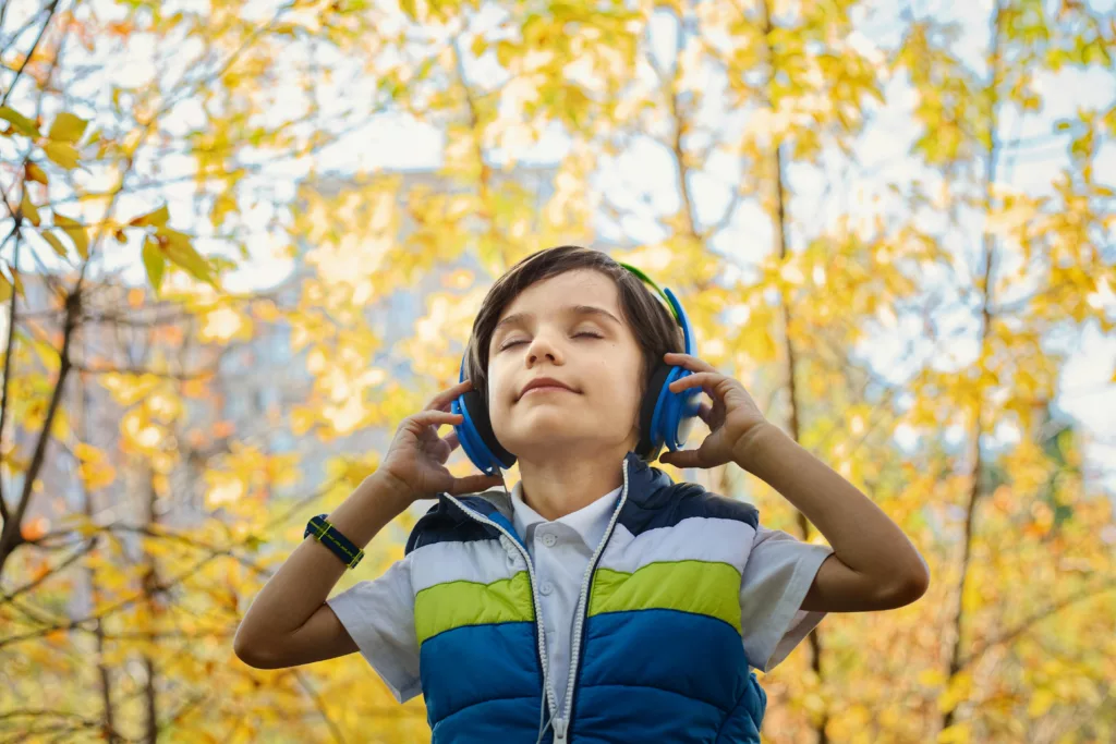 Un petit garçon écoute une histoire via son casque audio
